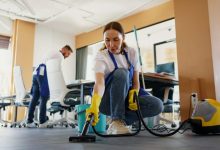 professional cleaning service person using vacuum cleaner office e1695048392527